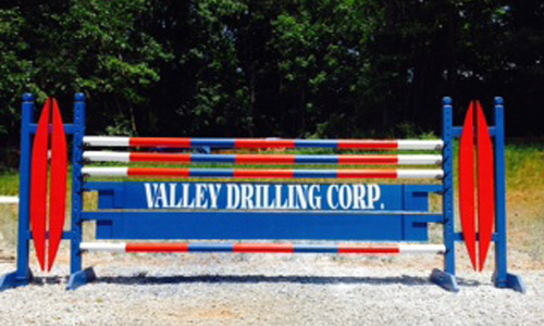 Valley Drilling sponsored horse jump with Dapple Equine horse jump cups